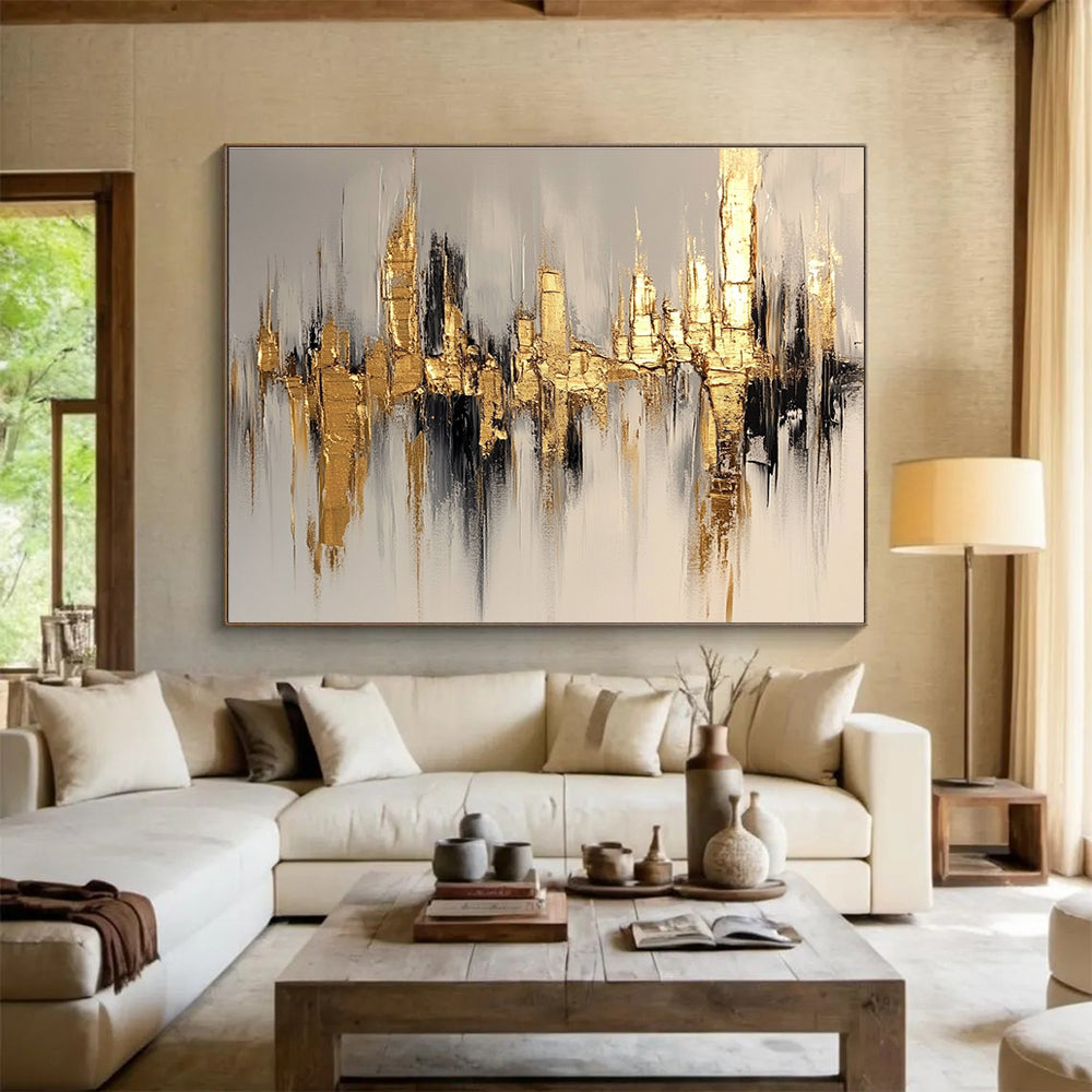 Large abstract painting of a cityscape in gold and white, featuring bold brush strokes on a white background with neutral tones.SC170