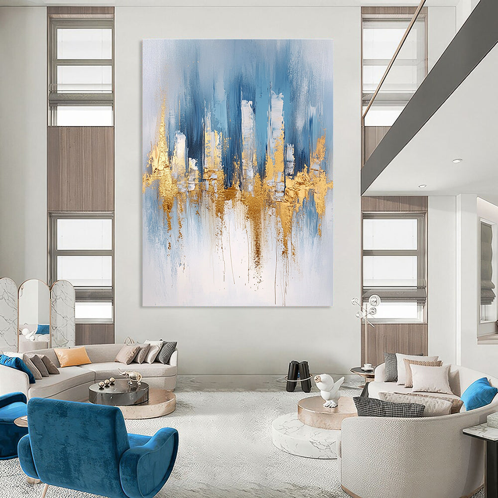 Large abstract blue and gold painting with urban landscape details light gray brushstrokes and elegant gold foil accents on canvas edges.STSC033