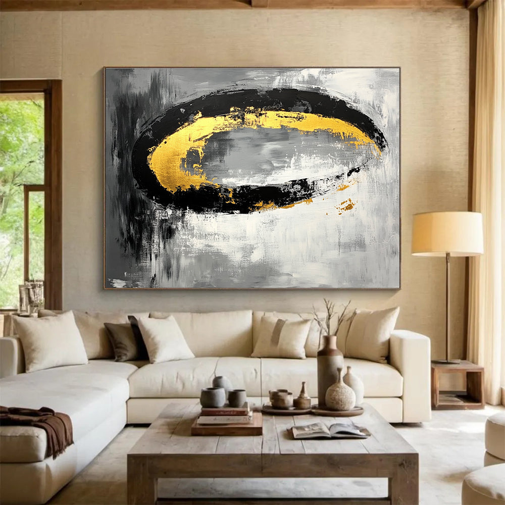 Large abstract painting featuring black white gray tones with gold accents and oval brush strokes on canvas.SC137