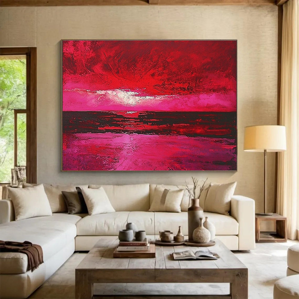 Large abstract painting depicting a red sky over the sea with hues of pink and crimson capturing the beauty of a sunset.SC273