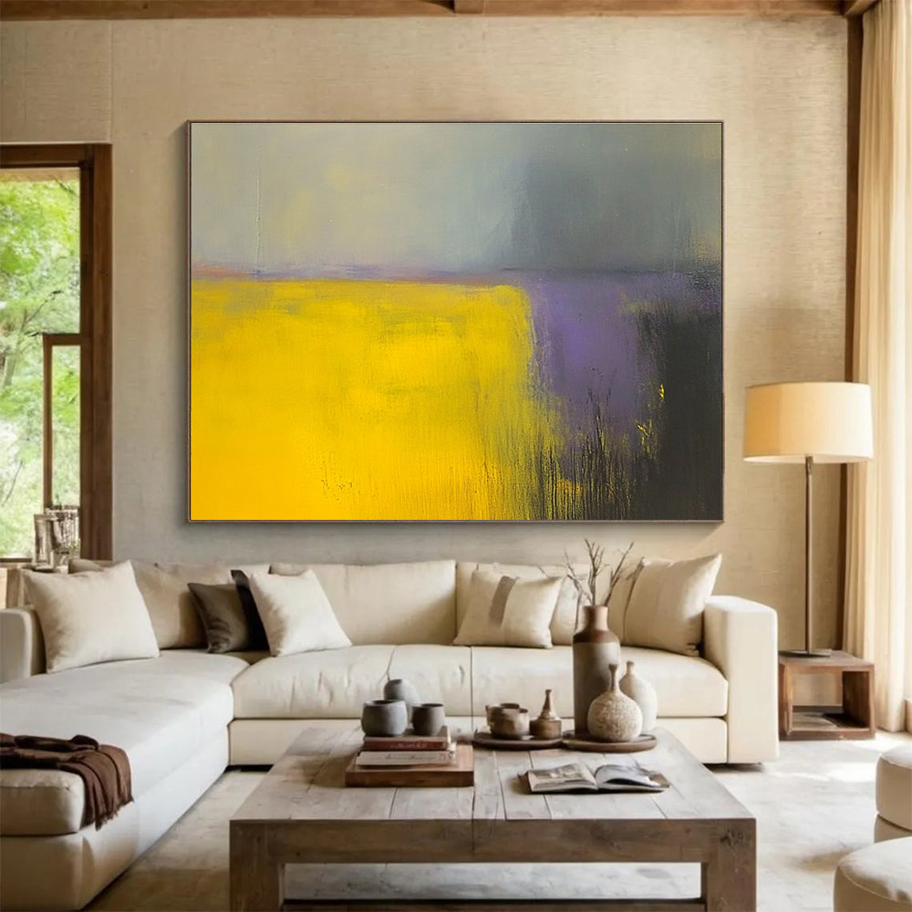 A large abstract painting featuring vibrant yellow and gray fields with subtle purple hues, enhanced by dynamic brushstrokes and a blurred background.SC475