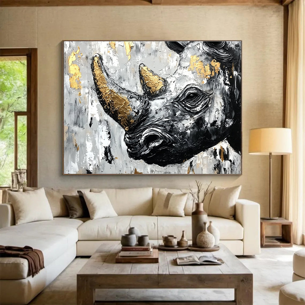 Abstract painting of an African rhinoceros in black and white with gold accents and textured strokes on a neutral background.SC151