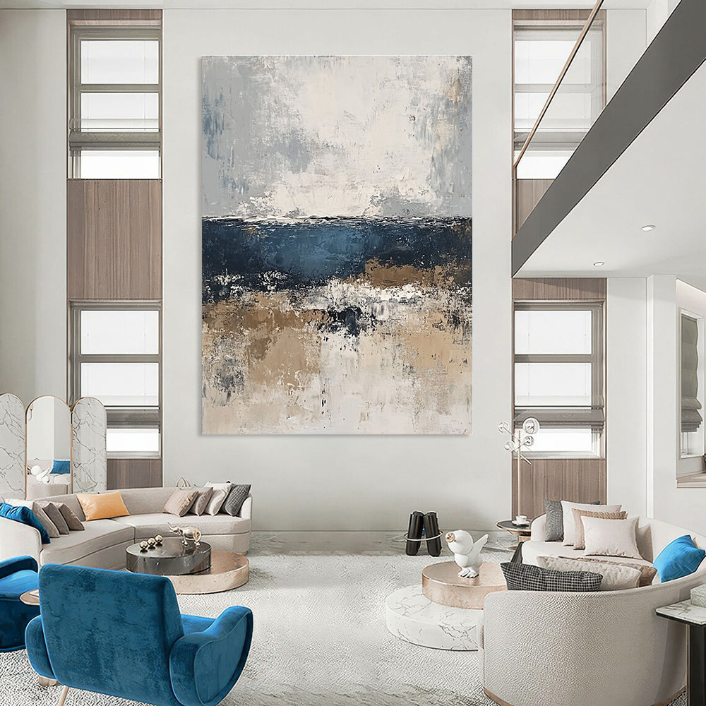 Large abstract painting of the sea in gray and blue tones with accents of beige brown and white for a serene artistic touch.STSC343