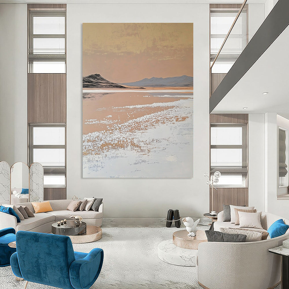 A large abstract painting features white salt crystals on a lake contrasting with textured brushstrokes in light beige and dark gold against a minimalist landscape.STSC1435