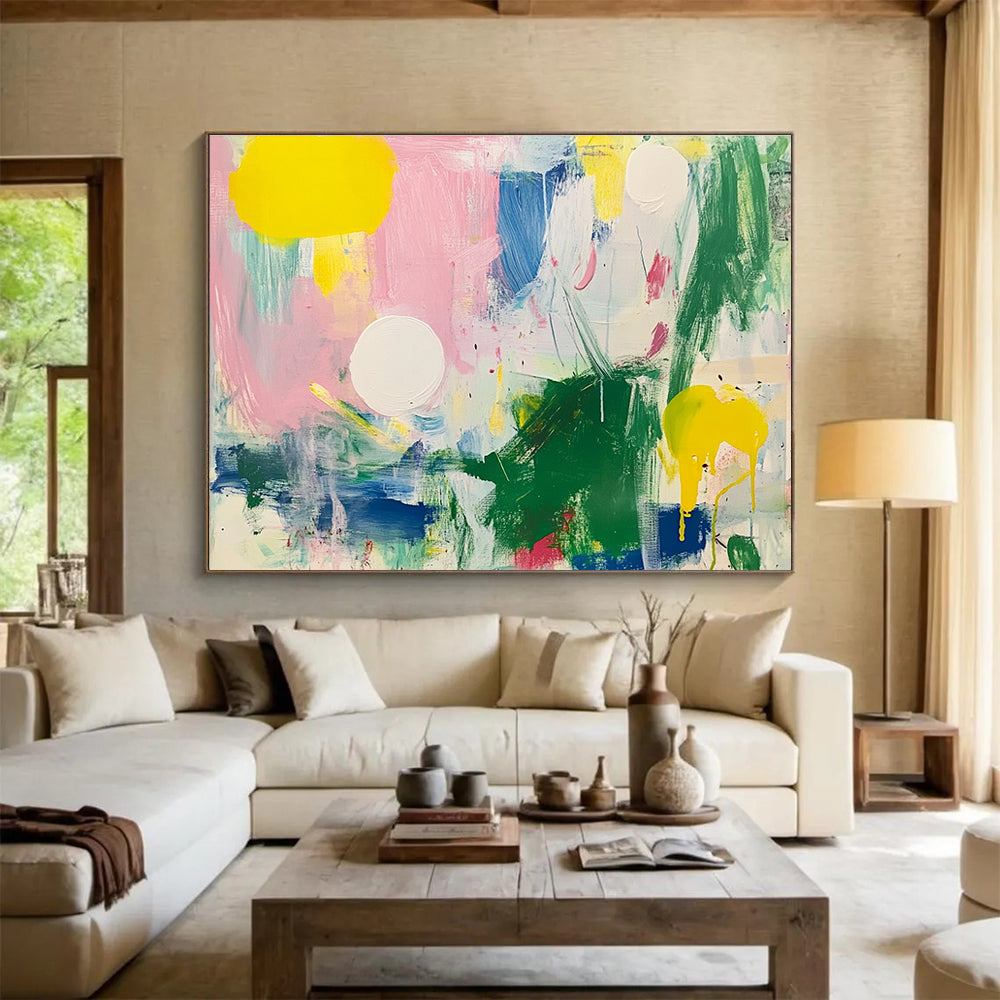 Large abstract painting featuring bright colors with green and pink shapes white circles yellow lines blue lines and light red elements on a white background.SC231