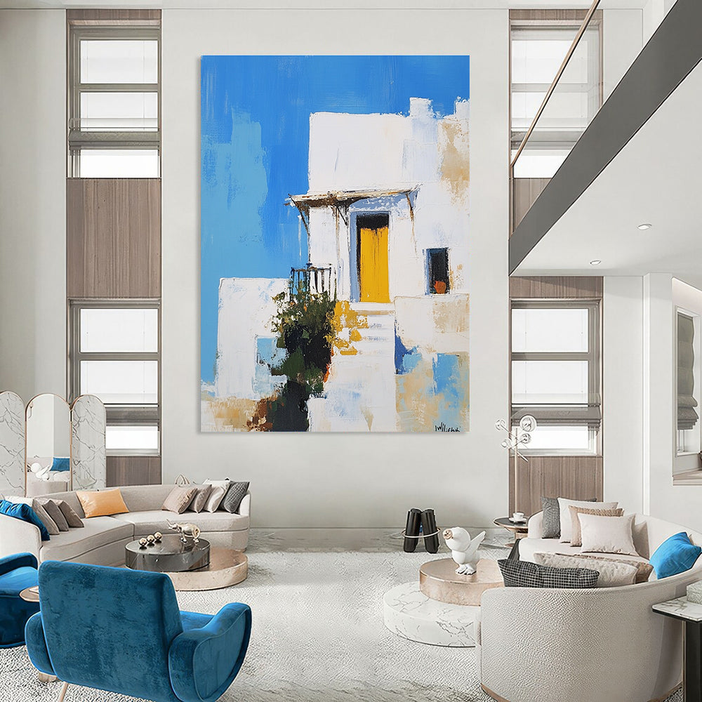 An abstract painting featuring a white Greek-style house with a yellow door against a blue sky inspired by Peter Wileman.STSC1253
