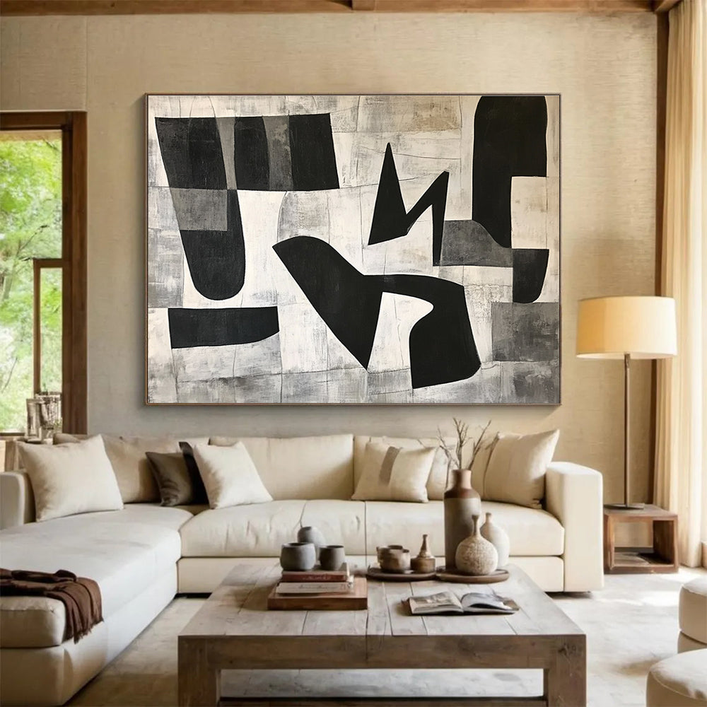 Large abstract painting featuring black and white geometric shapes in the letter K on a textured minimalist background conveying depth and movementSC517
