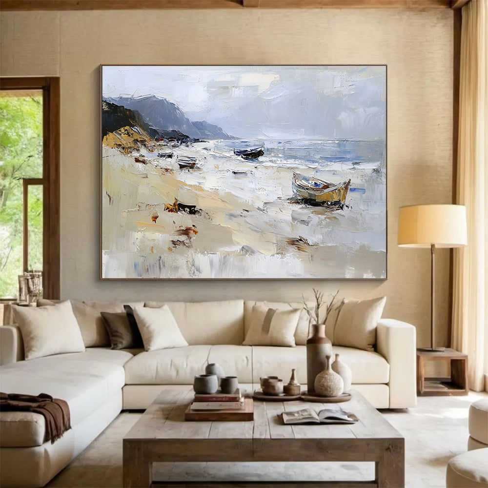 Large abstract oil painting of a beach with loose brush strokes featuring white gray and brown colors and visible sea spray and mountains in the background.SC605