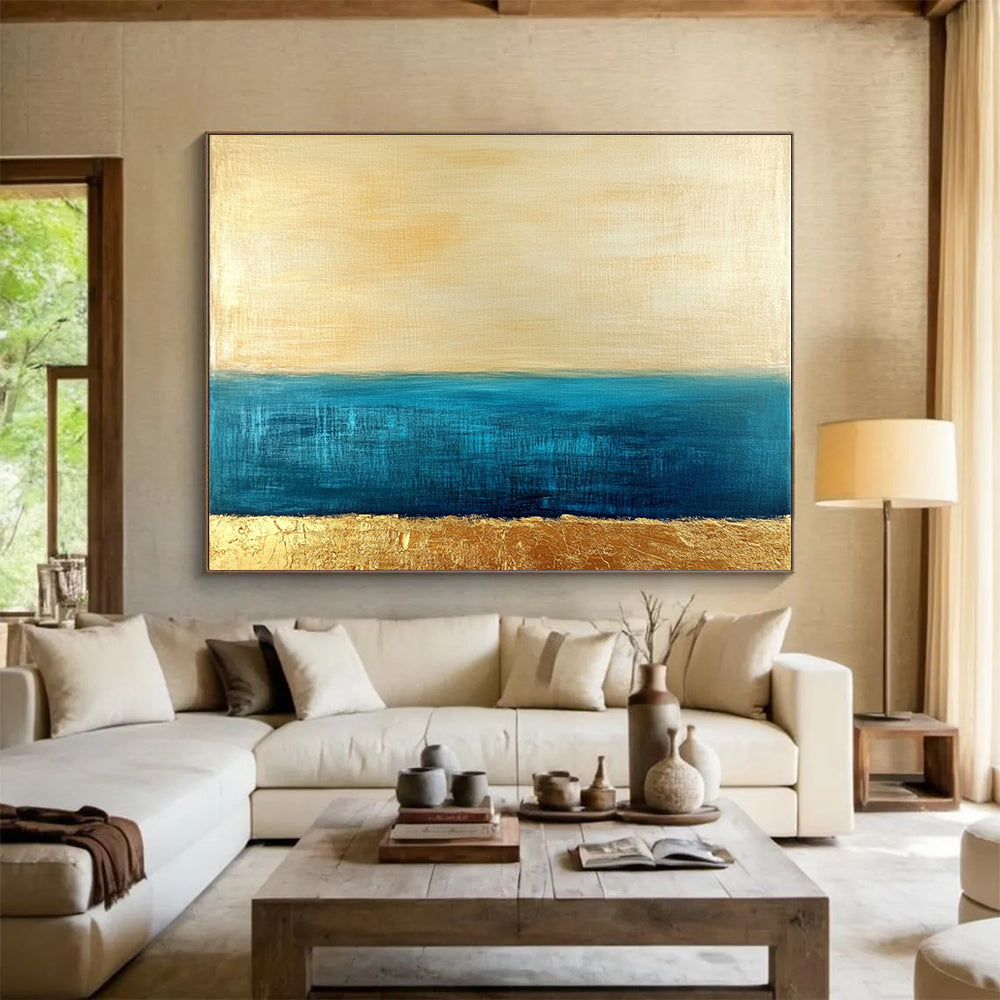 Large abstract painting featuring a golden sky and blue sea with textured gold accents and a soft minimalist aesthetic.SC172