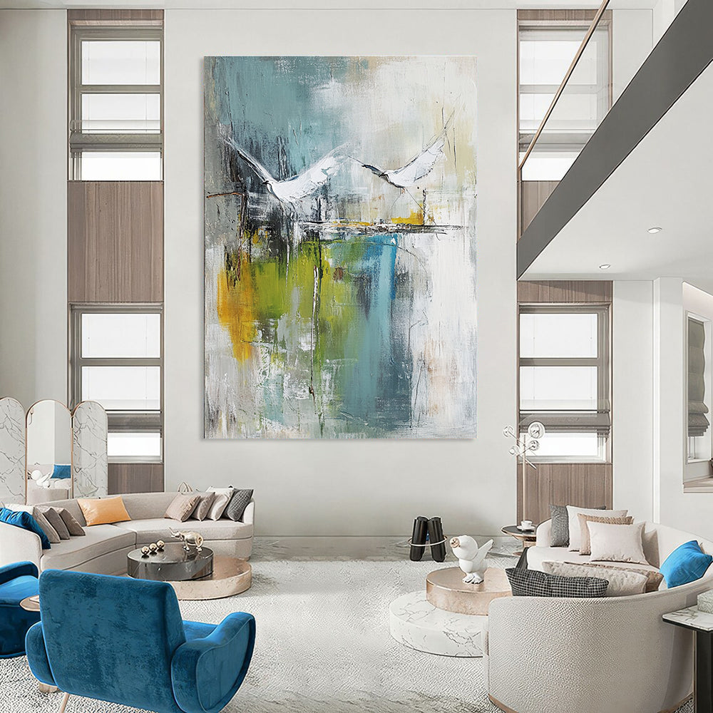 Large abstract painting of birds soaring over water in pale green and white with hints of blue beige and gray in a mixed media style.STSC303