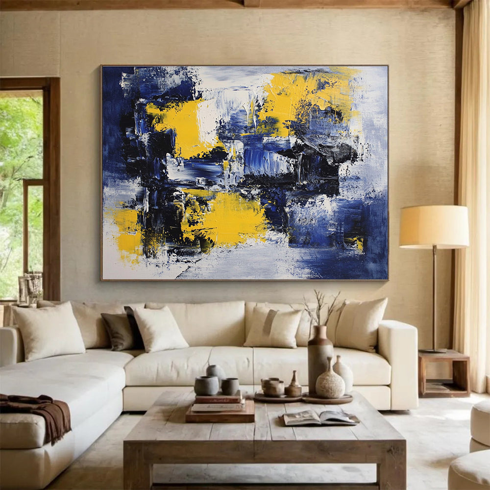Large abstract painting featuring deep blue, white, and yellow accents with impressionist brush strokes on canvas ideal for modern wall decor.SC031