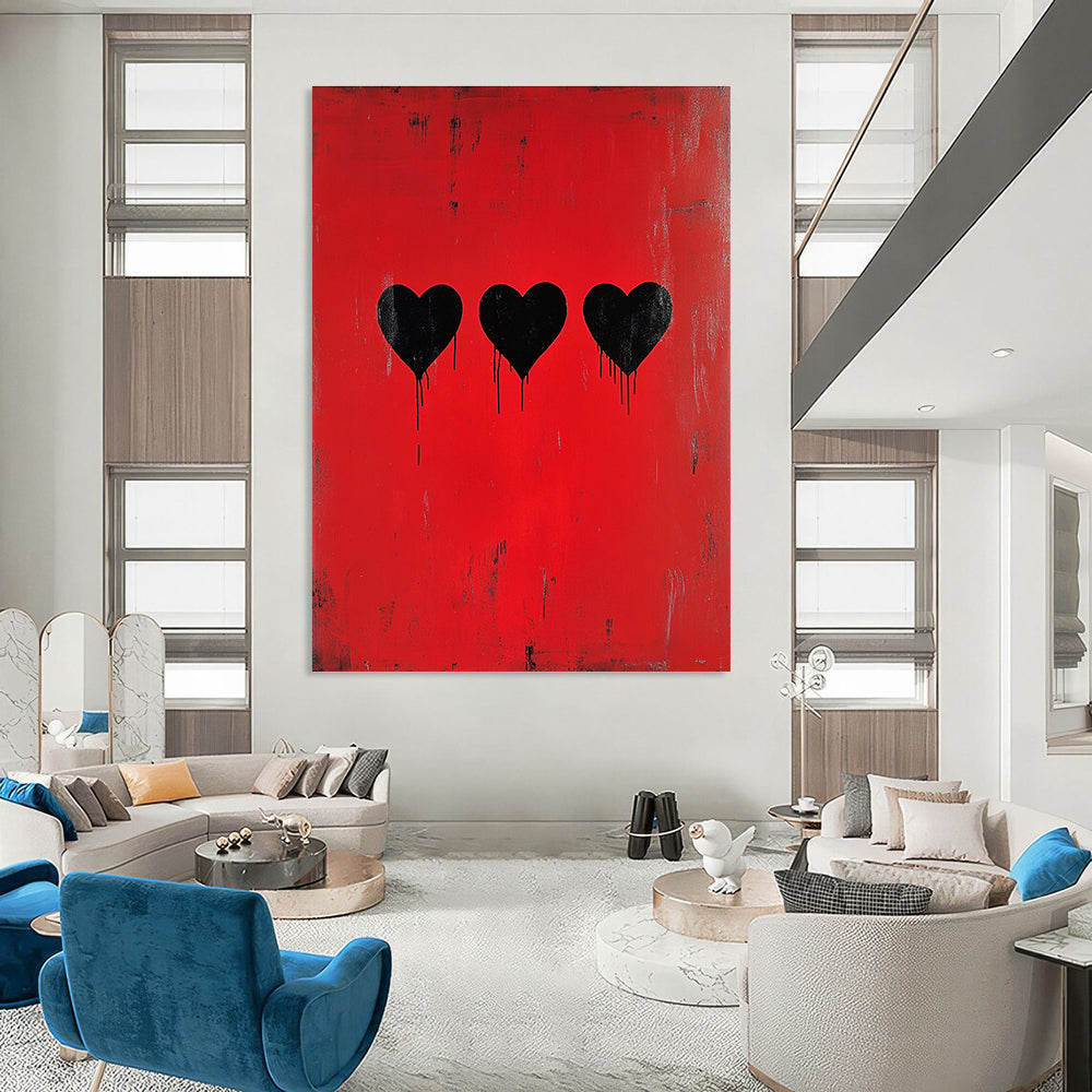 A large abstract painting featuring three black hearts on a red background inspired by Banksy’s minimalistic style.STSC1442