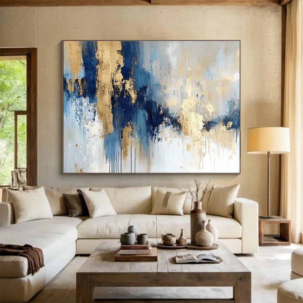 Large abstract painting in blue and gold with soft edges and texture featuring modern elegance and movement on a white background.SC021