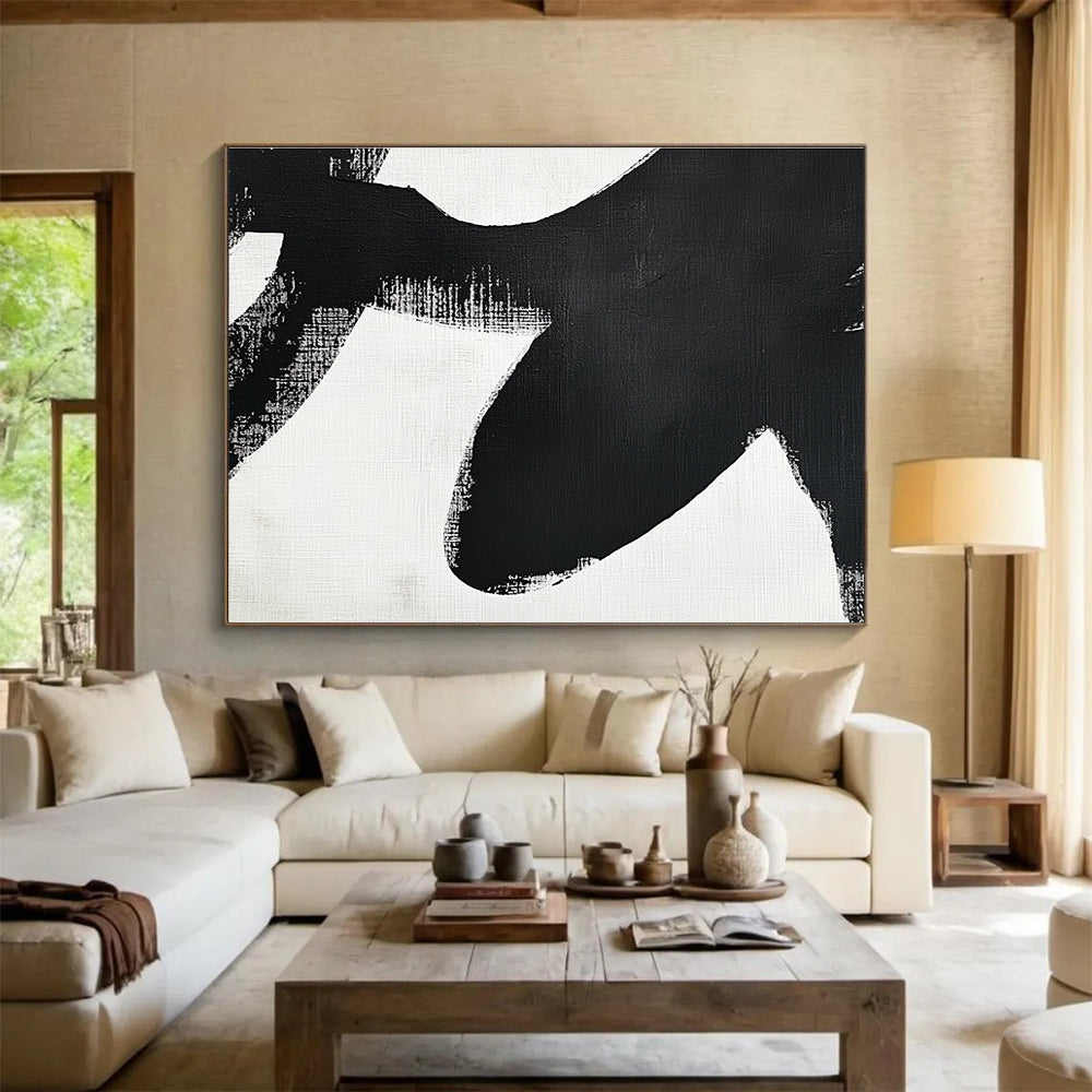 Large abstract painting in black and white featuring simple shapes and broad brush strokes inspired by an orca's tail flippers.SC016