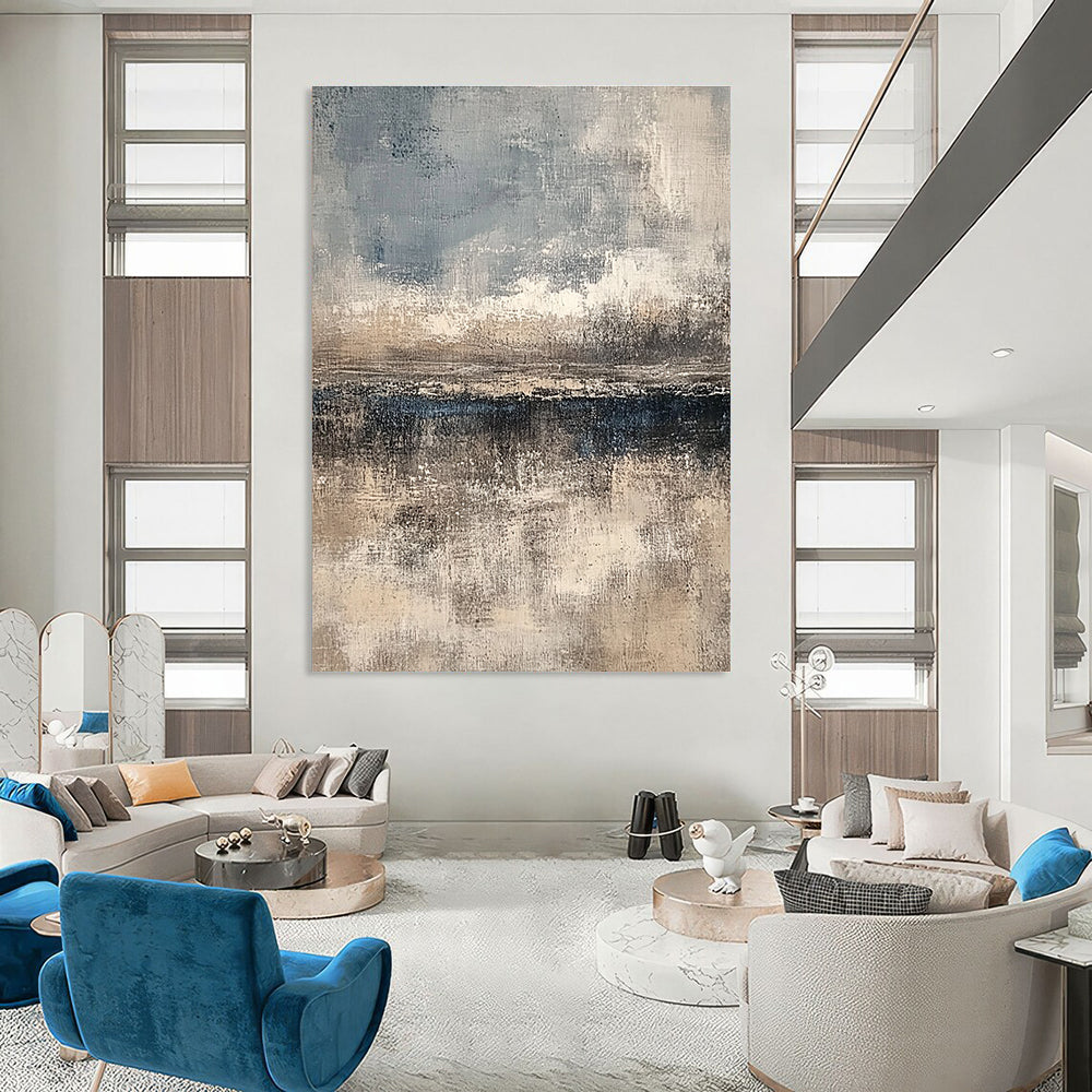 Large abstract painting featuring textured layers in neutral beige and gray with subtle blue and white accents creating depth and a serene horizon line.STSC108