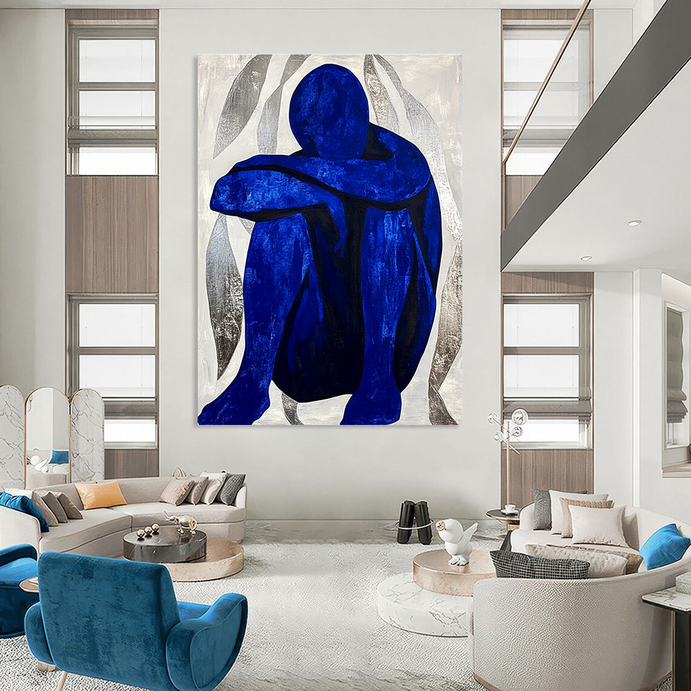 Large abstract painting featuring a contemplative blue figure amidst silver swirls, evoking tranquility and focus in a minimalist style.STSC922