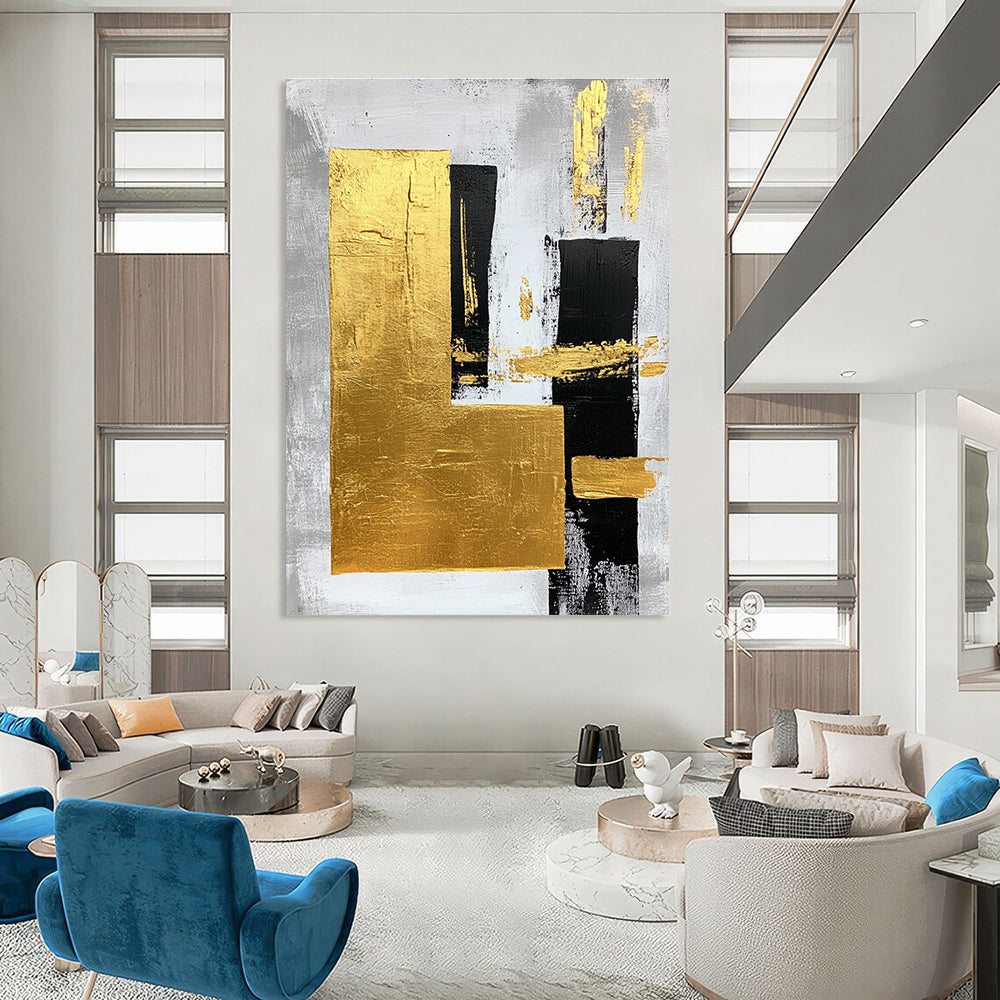 Large abstract art painting featuring gold foil bold strokes and minimalist black lines on a gray background creating an elegant atmosphere.STSC015