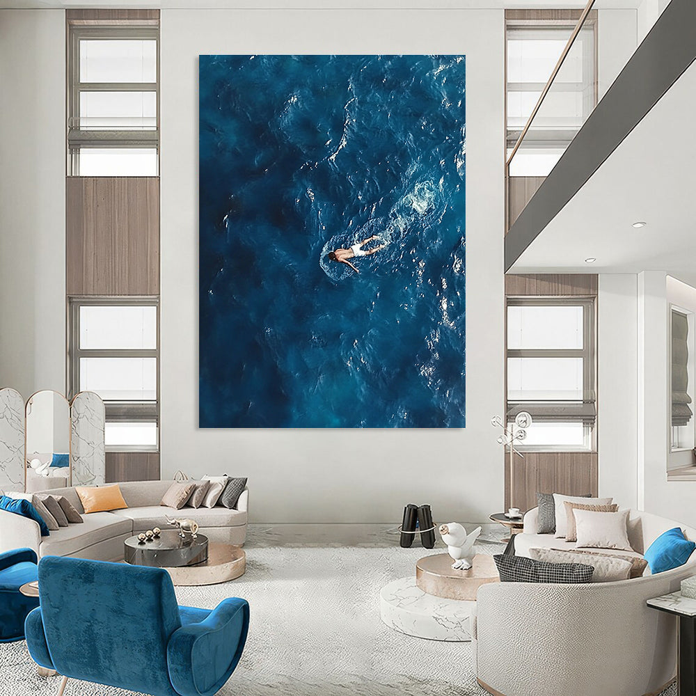 Large abstract painting depicting a solitary man in deep blue ocean waves wearing white swim trunks evoking solitude and calmness amidst chaos.STSC1057