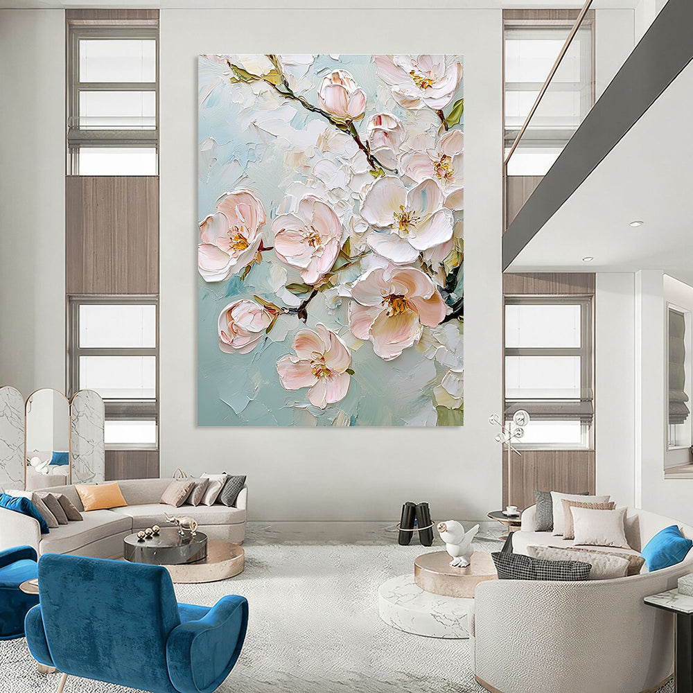 Large abstract painting featuring delicate cherry blossoms in soft pink and white against a light blue background with rich impasto texture.STSC875