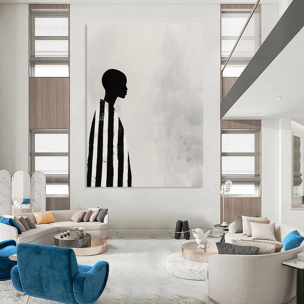 A large abstract painting featuring a striking black and white profile of an African woman in striped robes against a soft gray background.STSC1079