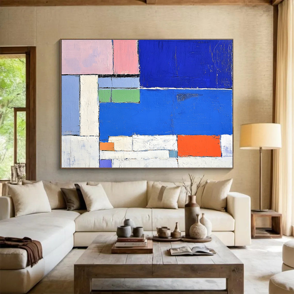 Large abstract painting featuring a vibrant blue sea white beach and colorful hotel with thick brush strokes and geometric shapes.SC169