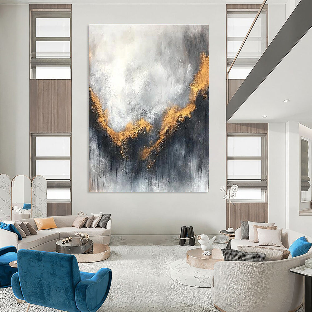 Large abstract painting with gray and white background golden accents atmospheric clouds and soft edges evokes calmness and introspection.STSC397