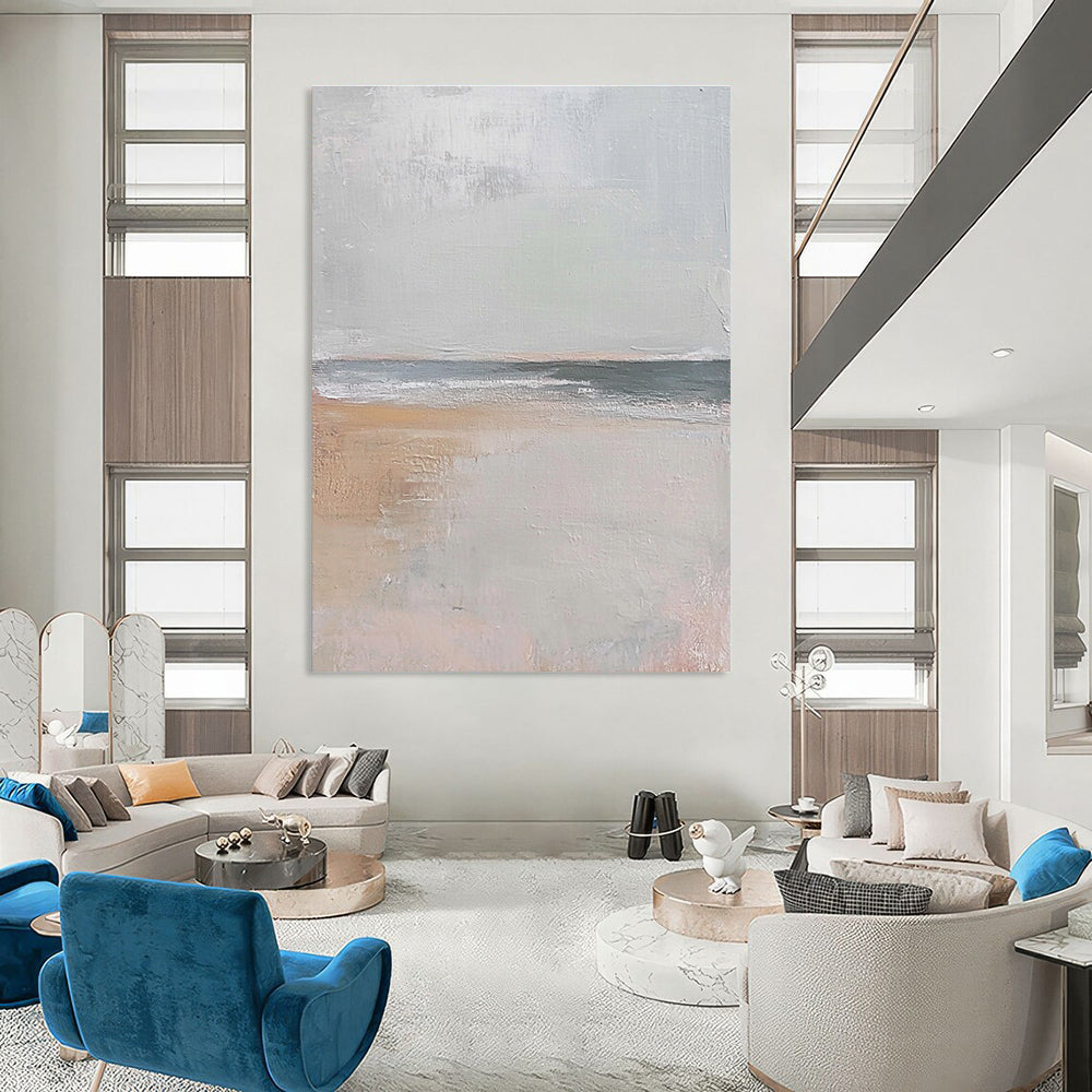 Large abstract painting in muted beige and gray tones featuring gentle brushstrokes of serene coastal scenery with hints of sandy textures and flying seagulls.STSC016