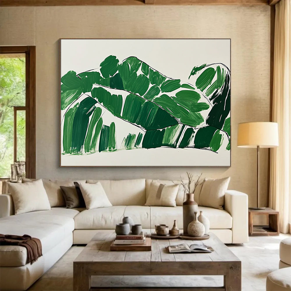 A large abstract painting featuring green leaves in the shape of a woman lounging on a couch with minimalist brush strokes on a white background.SC551