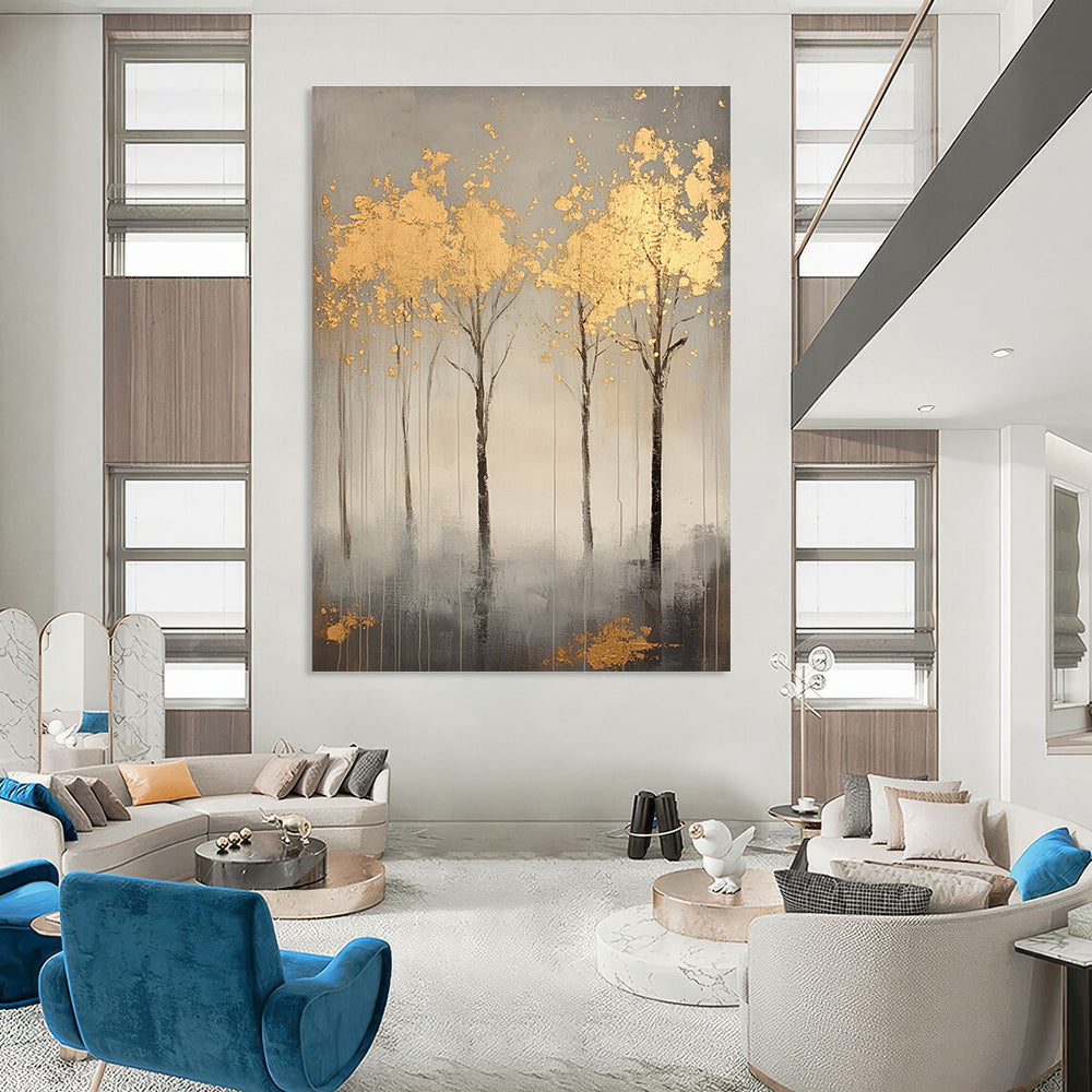 A large abstract painting featuring serene gray trees with gold leaf accents creating a tranquil atmosphere and evoking nature's beauty.STSC1174