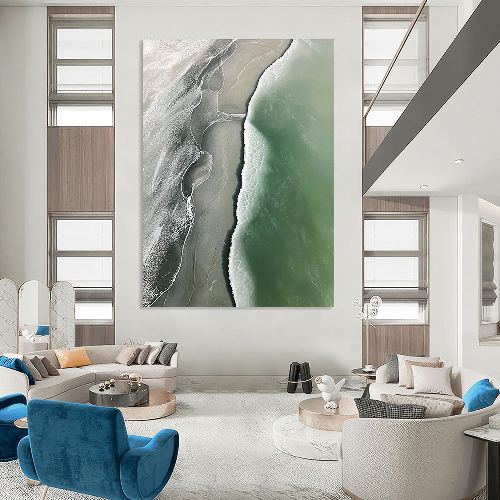 Abstract art piece featuring an aerial view of a beach with green and gray waves flowing onto white sandy shores.STSC529