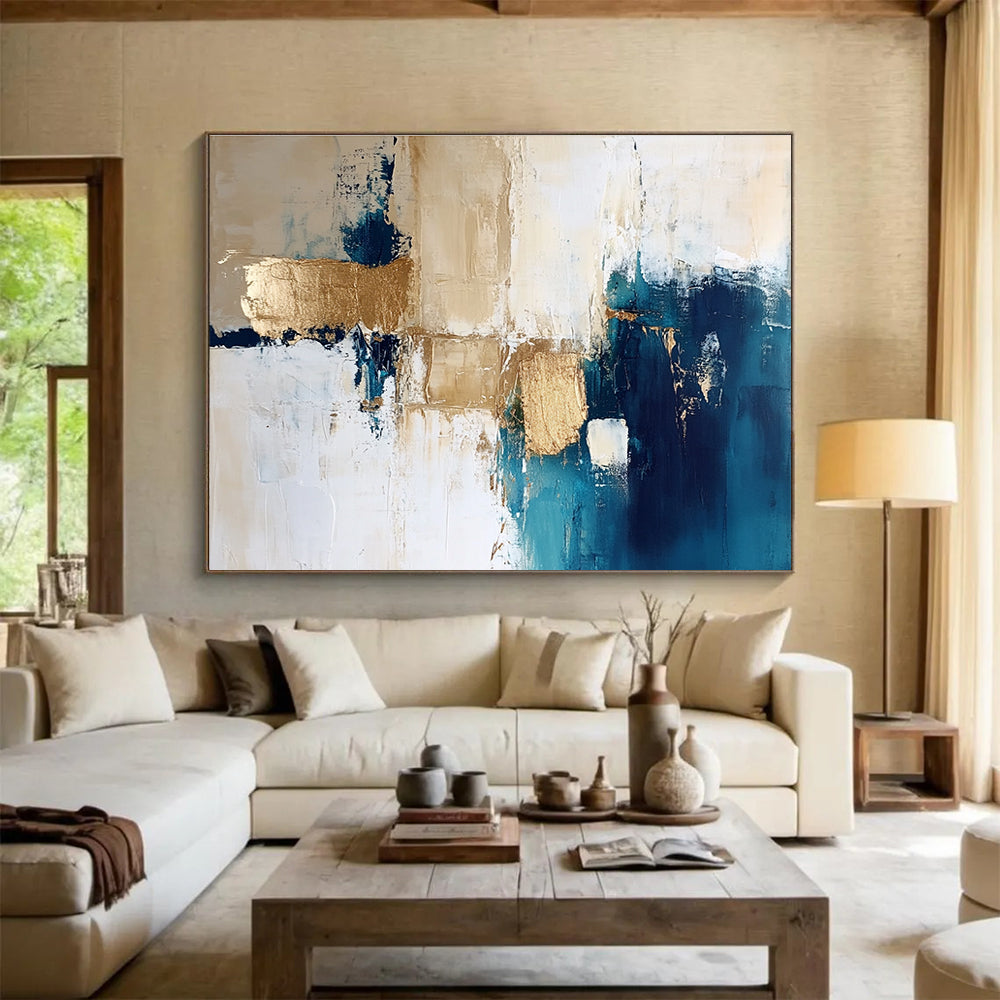 Large abstract painting in blue and gold with white beige and cream tones ideal for modern decor and artistic spaces.SC024