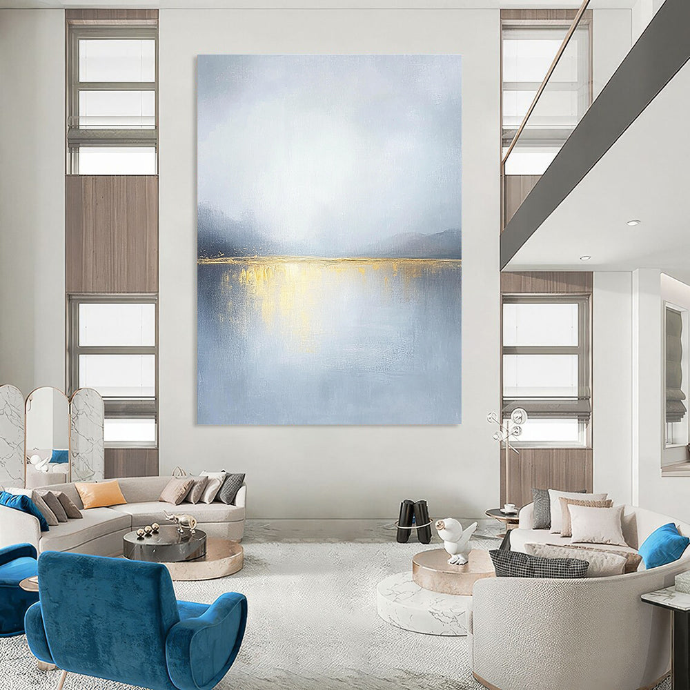 Large abstract painting of an overcast sky with golden water reflections soft tones and serene landscape capturing a tranquil mood.STSC271