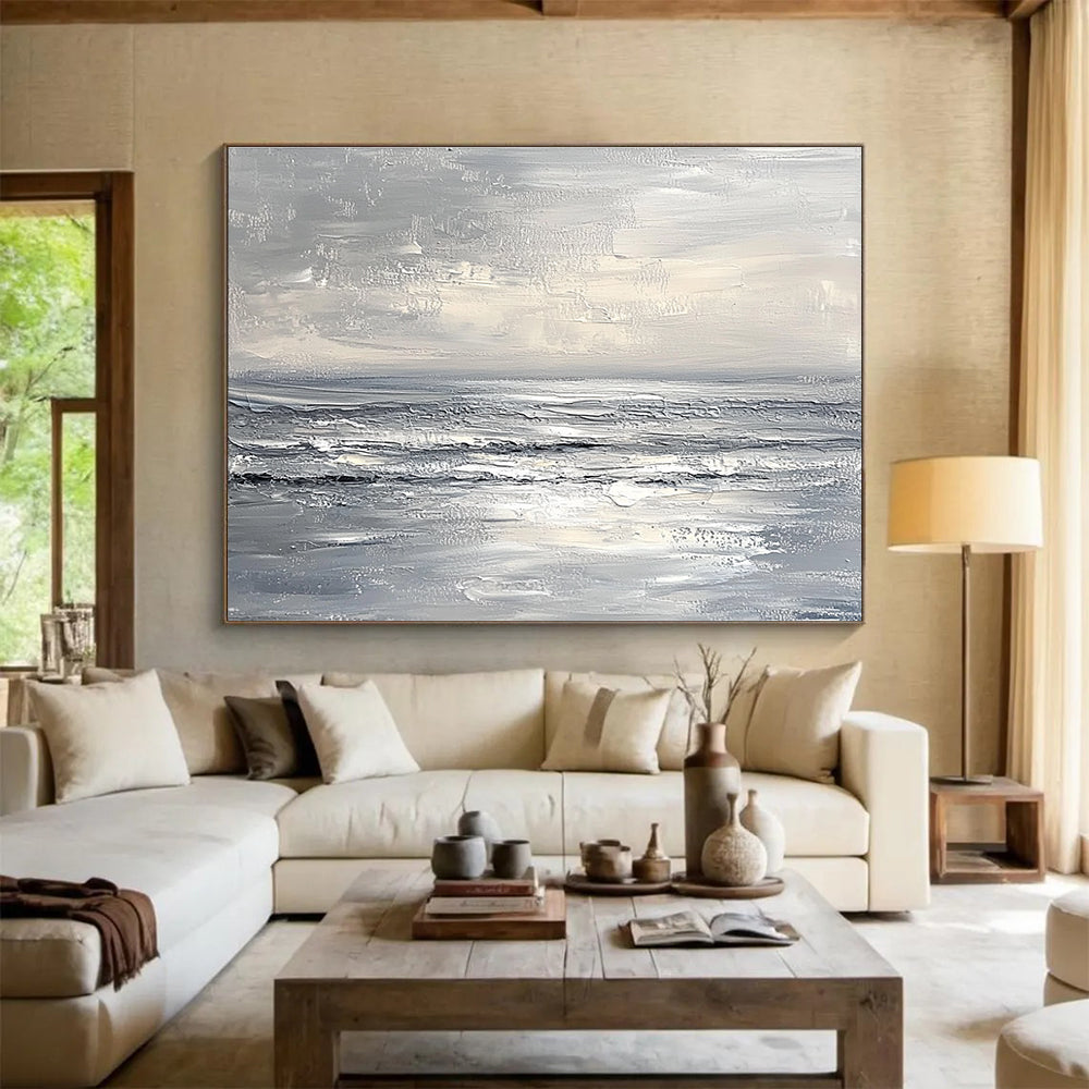Abstract seascape in impasto oil, featuring textured strokes in muted whites and greys, capturing a minimalist beach with soft waves and sky.SC276