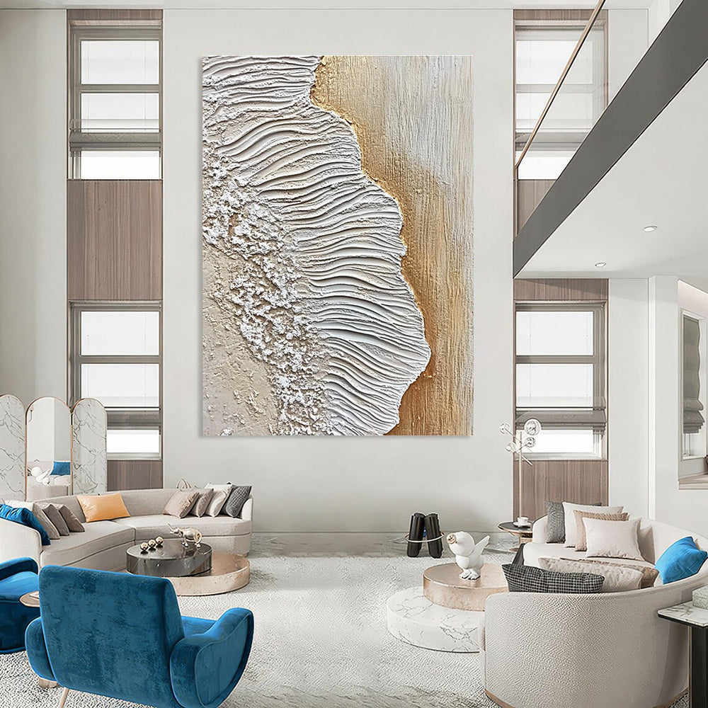 A large abstract painting featuring textured sand and waves in white and beige against an oak wood floor, embodying coastal elegance.STSC946