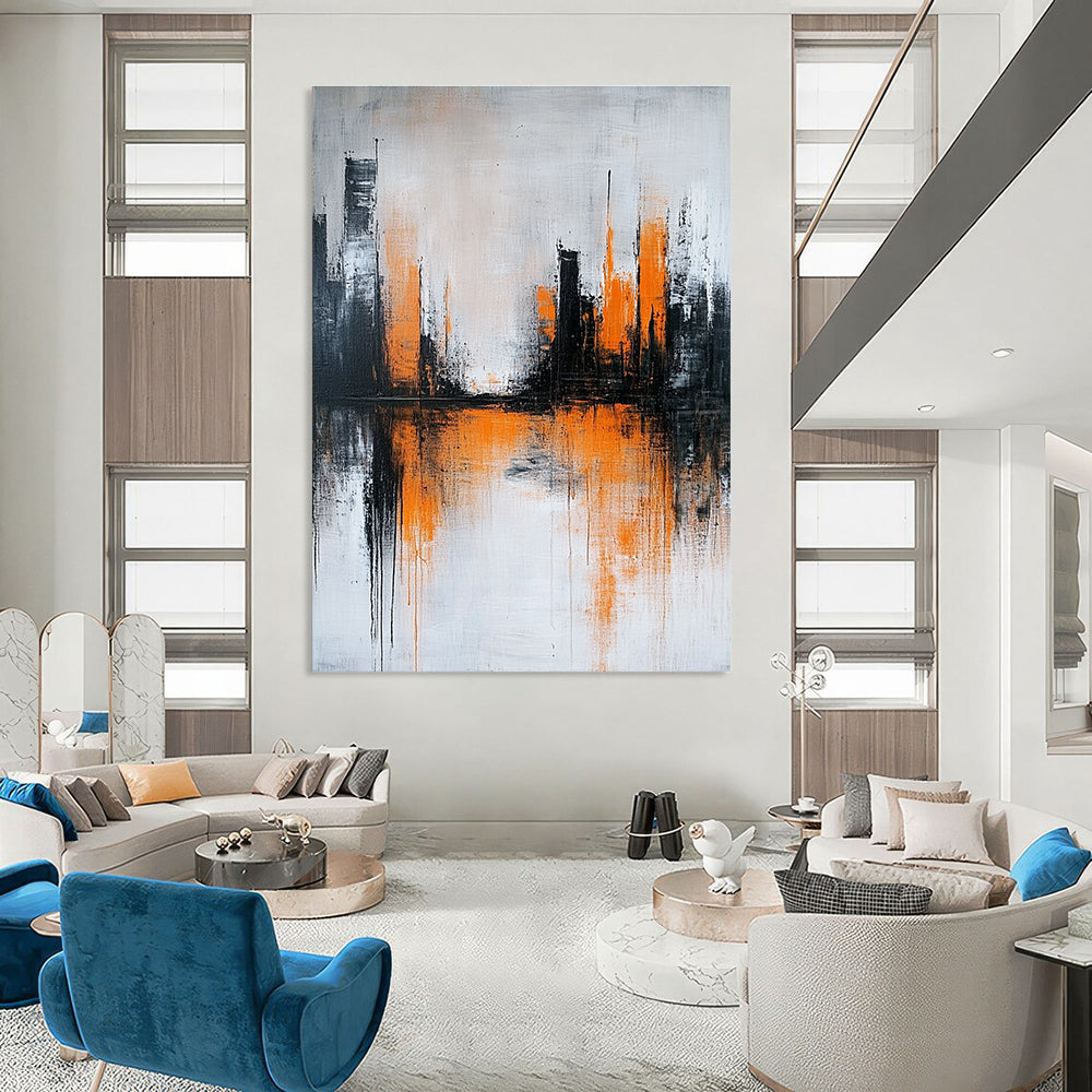 Large abstract painting featuring gray and white background with orange brushstrokes and urban landscape silhouette reflecting on water surface.STSC225