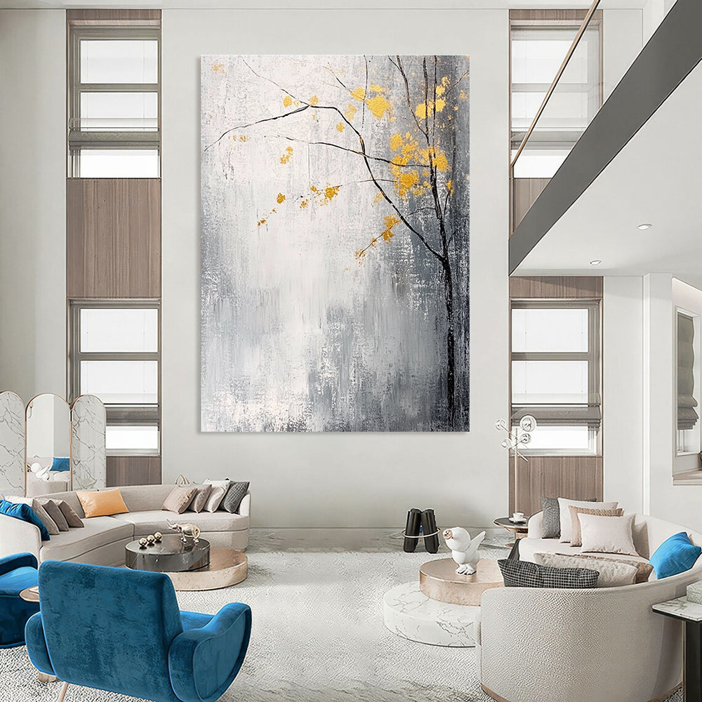 Large abstract painting with gray and white background yellow accents and delicate gold leaves creating a tranquil and mysterious atmosphere.STSC395