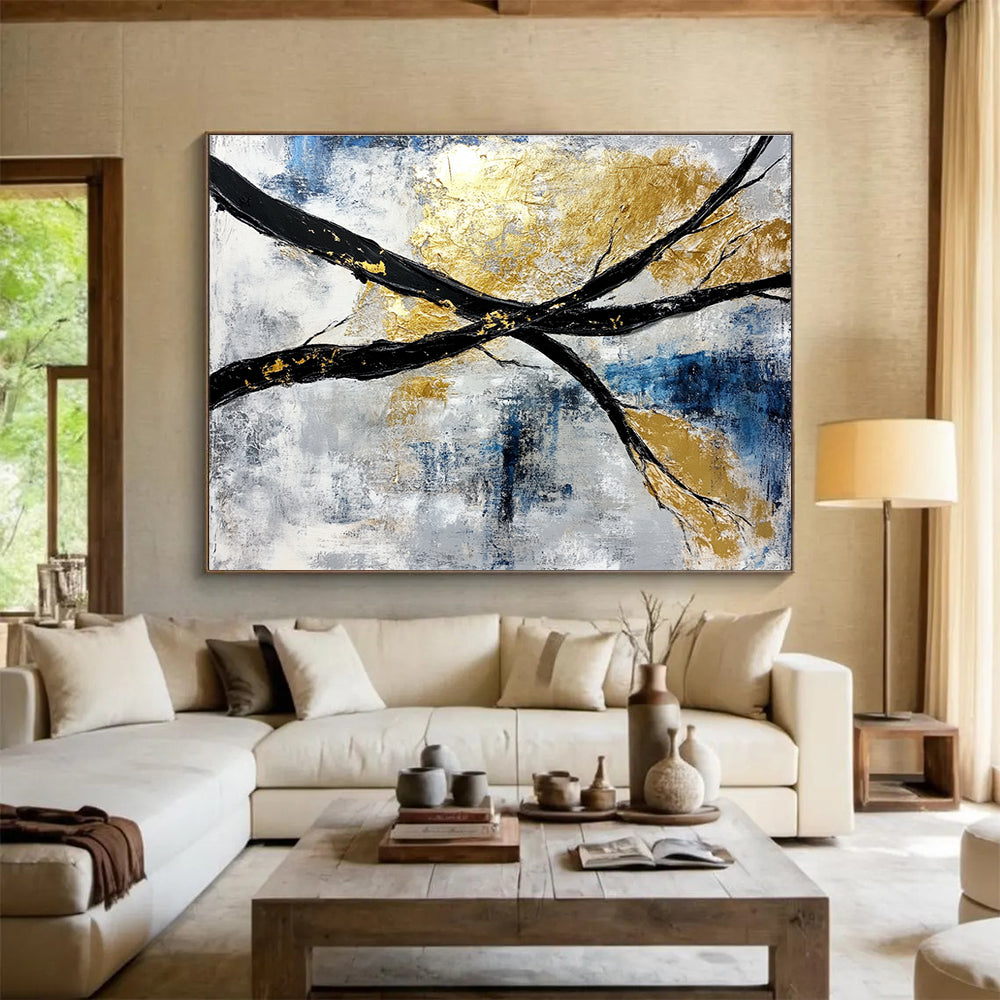 Abstract painting featuring black and white branches with gold leaf accents against a serene blue sky background.SC367
