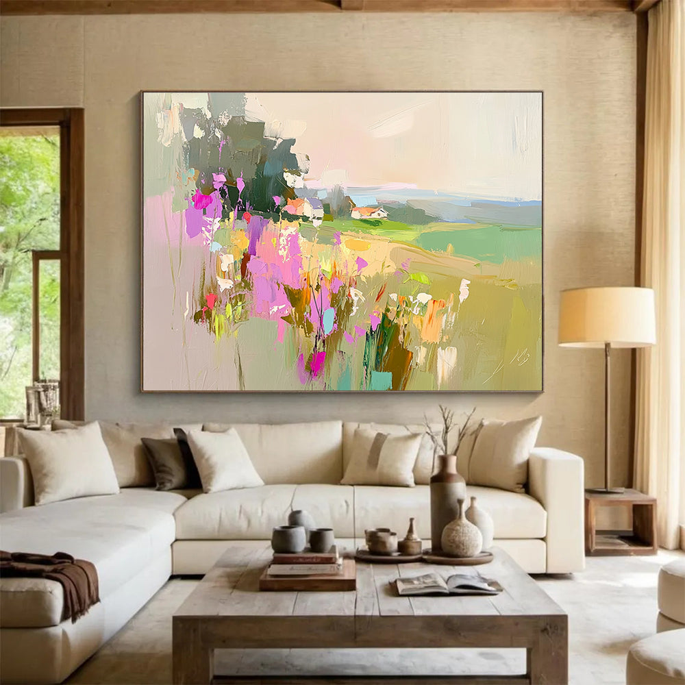 Large abstract painting featuring a floral landscape with fields and a distant cottage in soothing pink purple green and blue tones.SC110