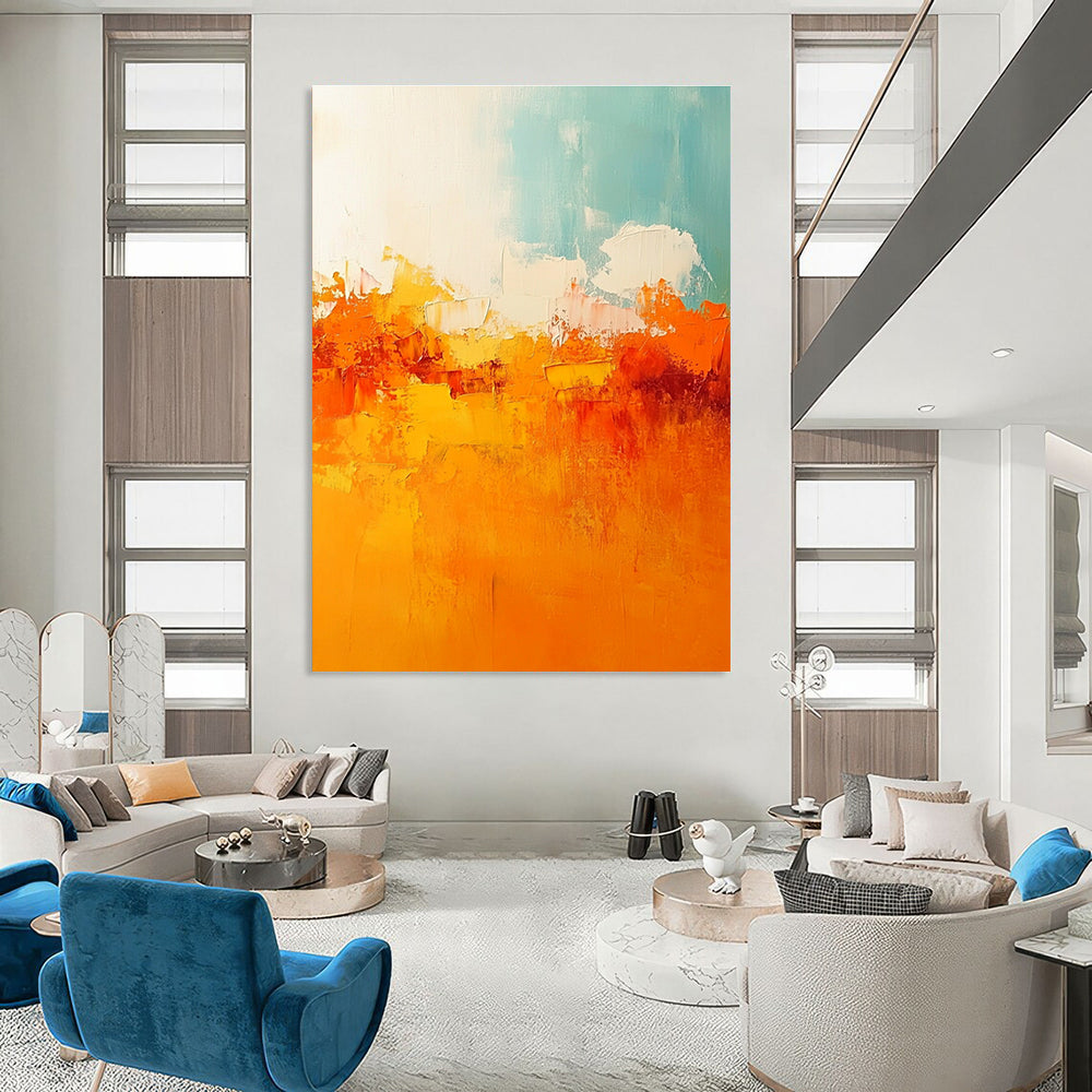 Large abstract painting featuring warm tones of orange and yellow with soft edges and brushstrokes depicting a serene sunset sky.STSC119