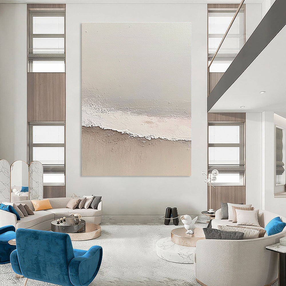 Large abstract painting depicting a serene beach scene with soft gray and pale pink tones featuring gentle waves and textured surfaces.STSC1427