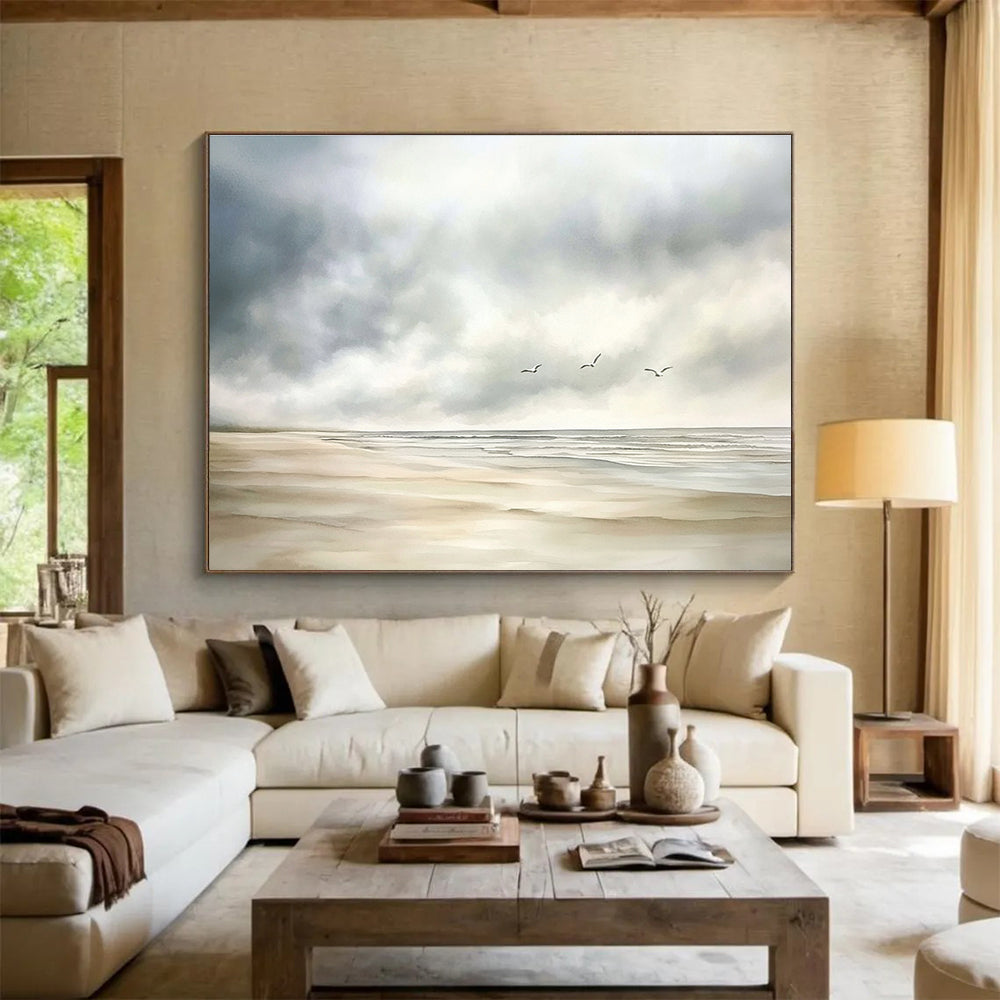 Large abstract watercolor depicting a calm beach scene with muted colors, seagulls in the distance, and a soft cloudy sky on a white background.SC616