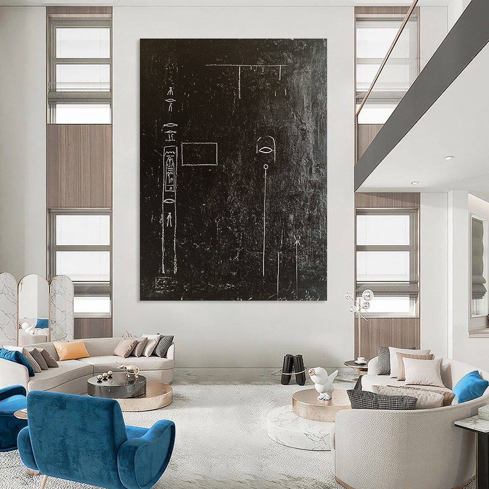 A large abstract painting featuring a black wall adorned with white chalk drawings of ancient Egyptian symbols and writing in high contrast.STSC918