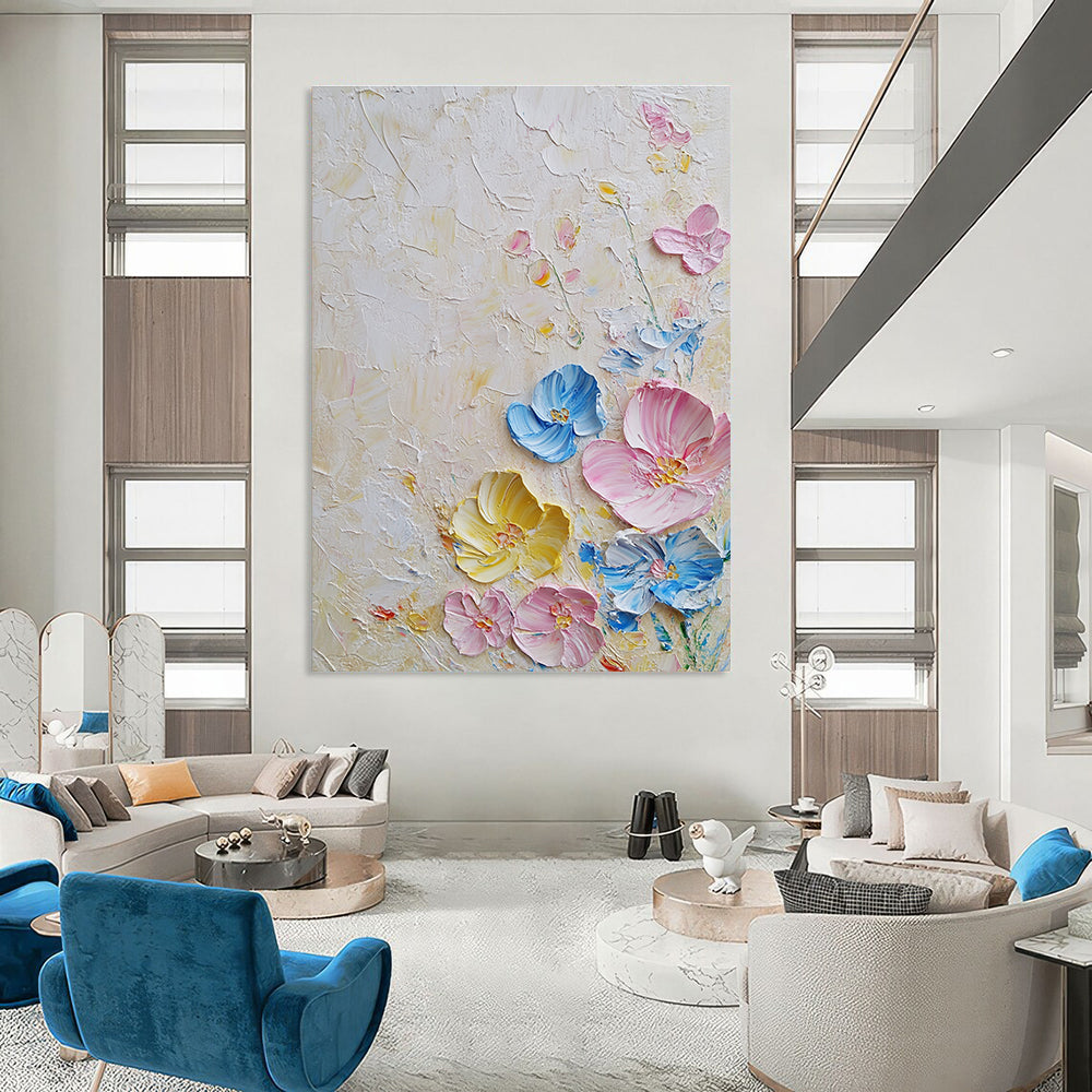 Large abstract painting with textured layers featuring pastel flowers in pink and blue on a white background illuminated by soft lighting.STSC1366