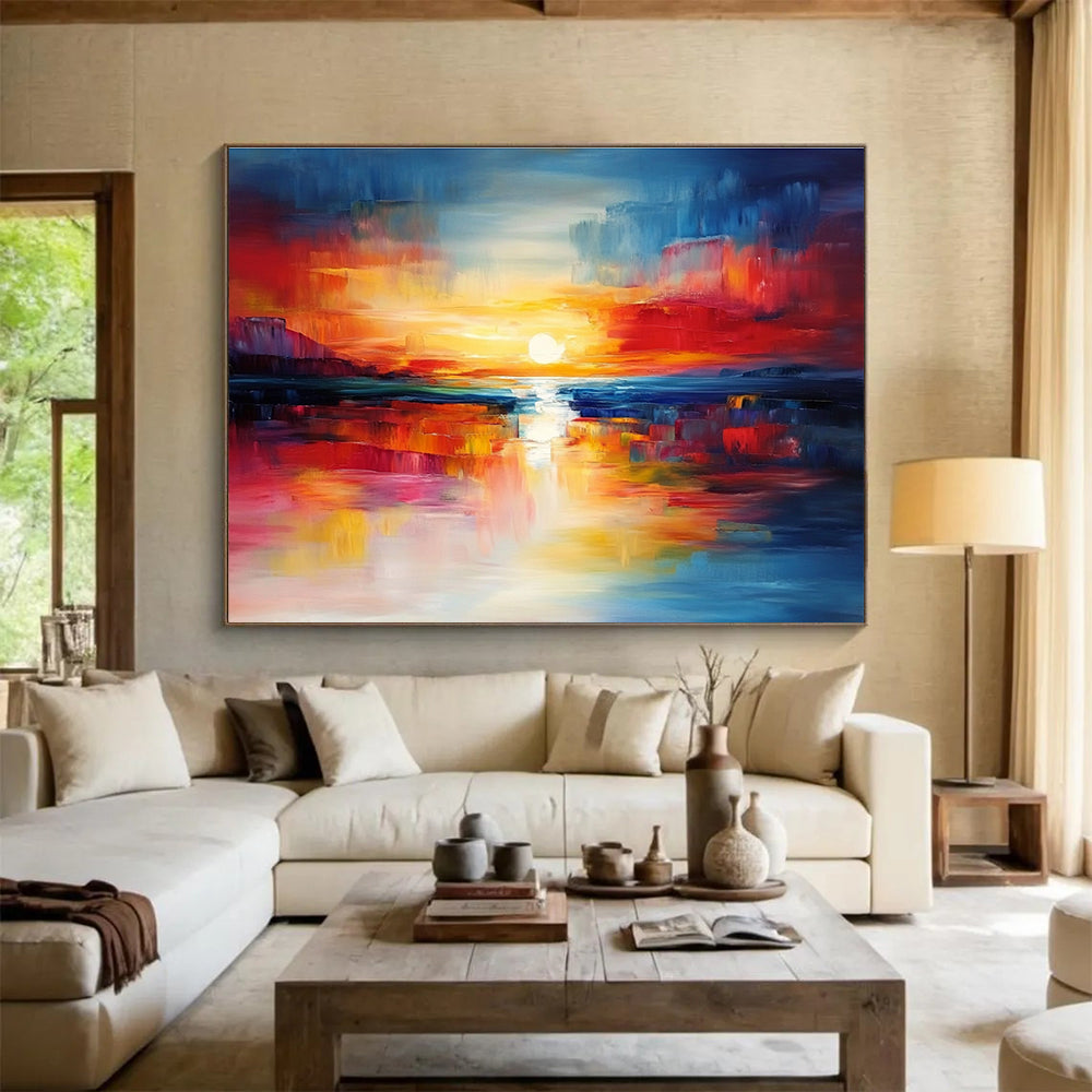 A large abstract painting capturing a vibrant sunset with blue and red hues reflecting on calm waters, creating a dynamic central composition.SC561