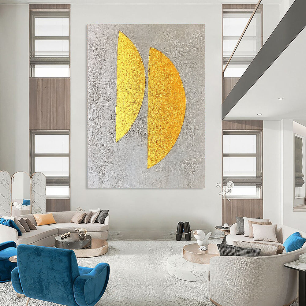 Large abstract painting featuring two yellow semicircles on a textured grey background with gold leaf highlights in a minimalist style.STSC356