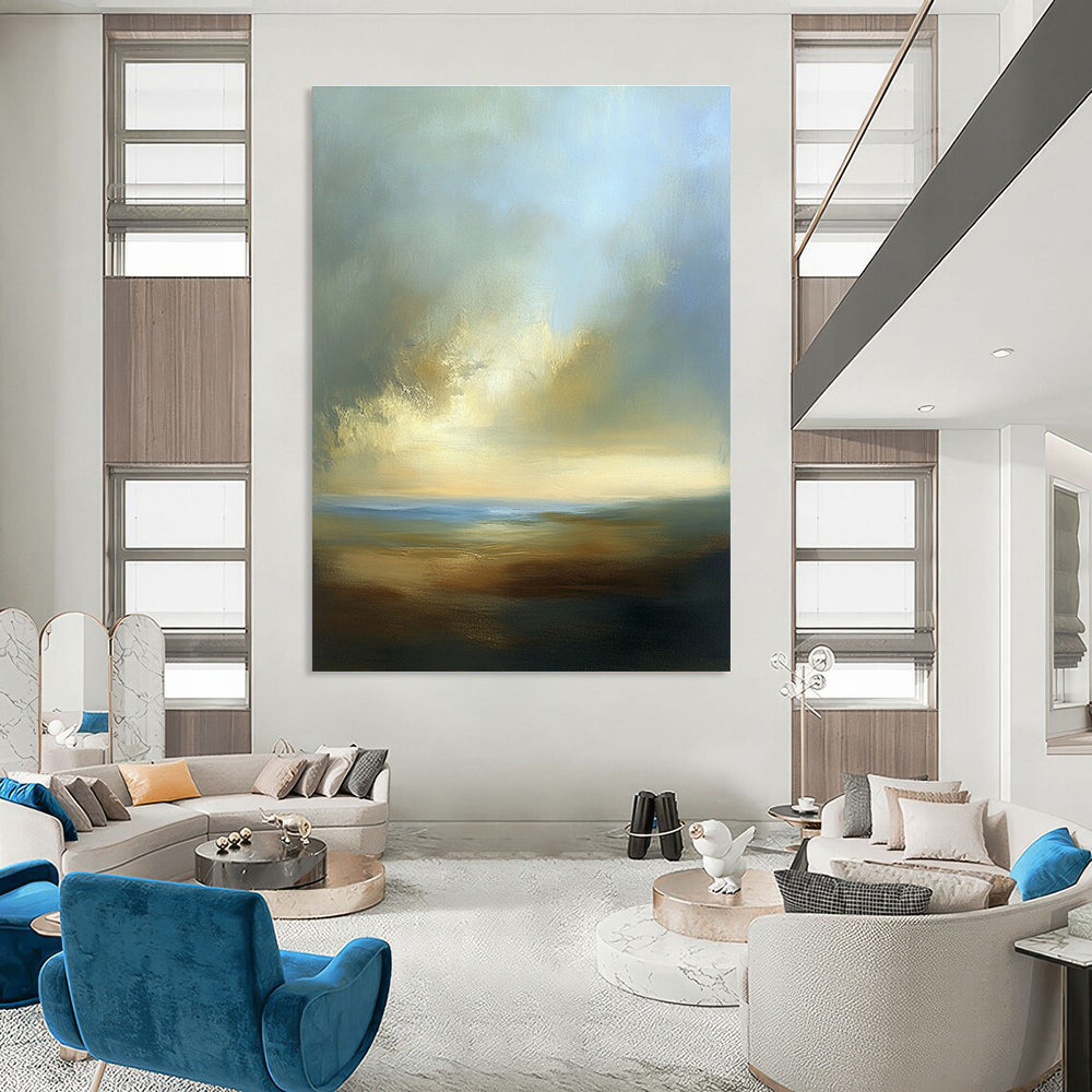 Large abstract painting depicting a dreamy sky with soft blues browns whites and beige clouds over a serene horizon at sea level.STSC886