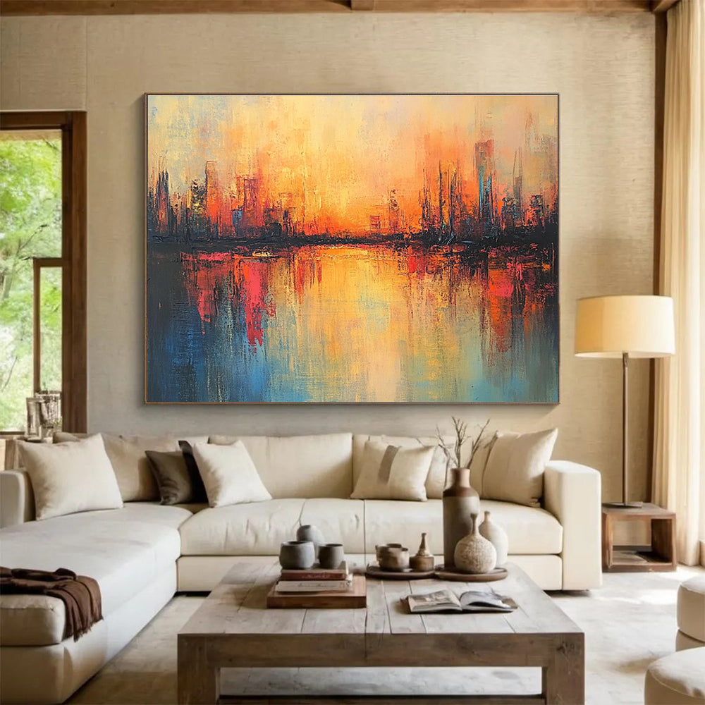 Large abstract painting featuring a cityscape in warm hues with soft brush strokes and reflections on calm waters, evoking a serene sunrise atmosphere.SC037