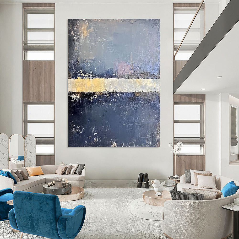Large abstract painting in faded hues of blue gray and pale yellow with soft edges on a dark gray background featuring a white bar.STSC218