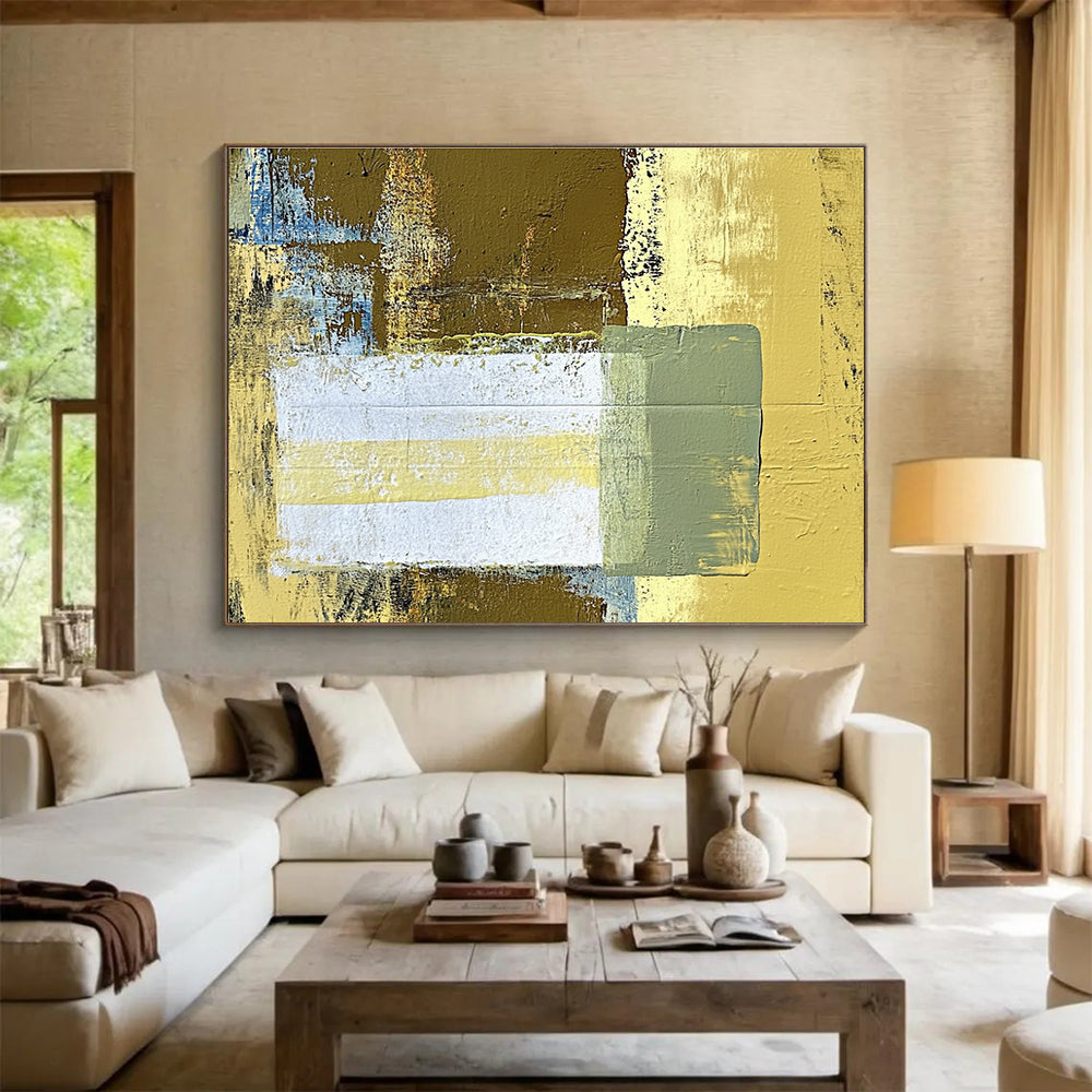 Large abstract painting featuring beige and yellow tones with a central white rectangle and green stripe against a dark brown background.SC425