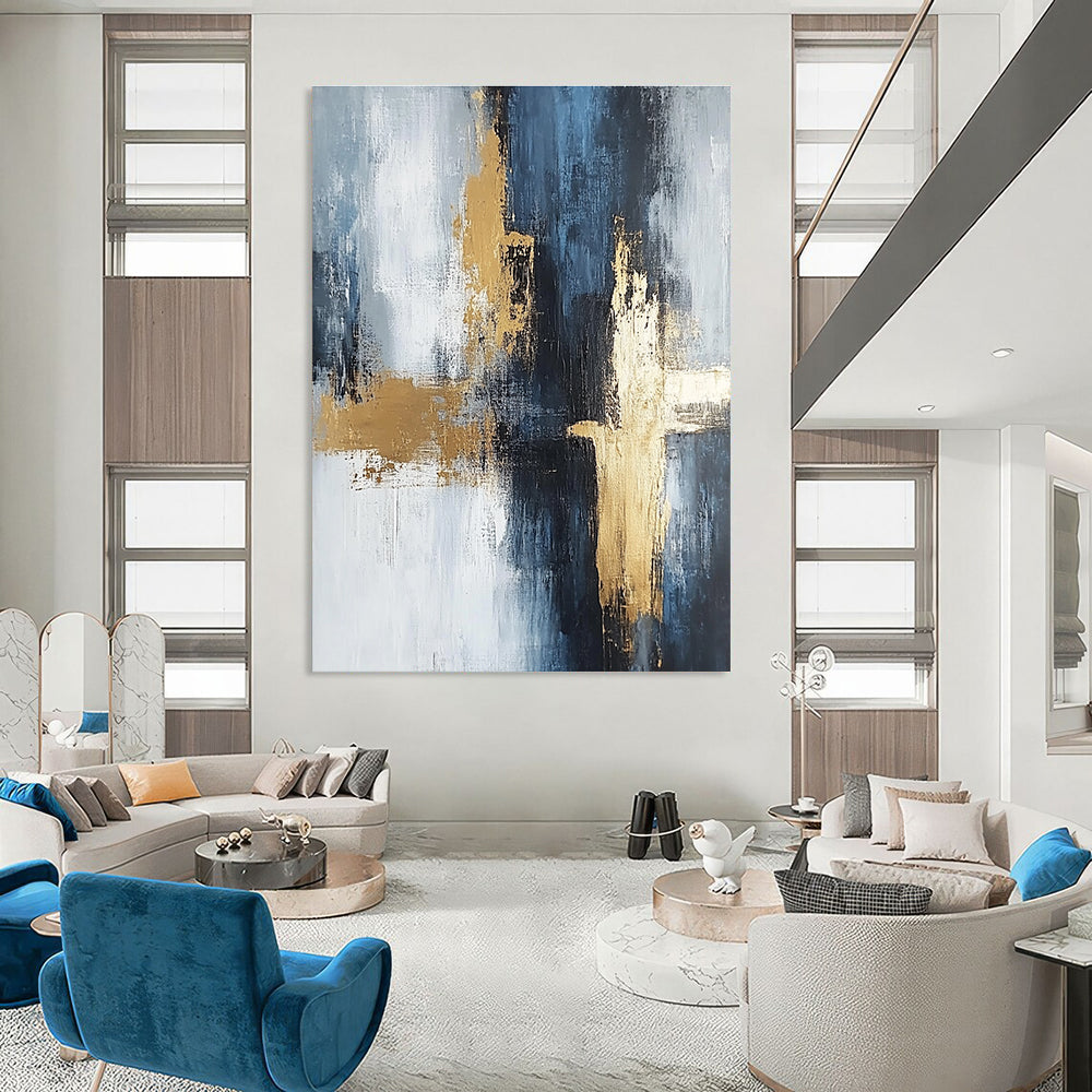 Large abstract painting in light gray and dark blue tones with gold accents featuring strong brushstrokes and delicate textures creating spatial depth.STSC433